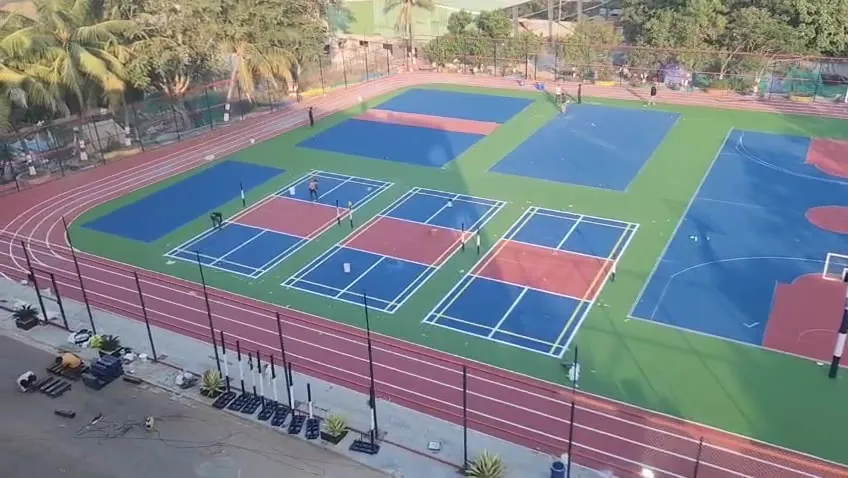 Aerial view of a multisport complex with courts and a synthetic running track built by Kelysports in Hyderabad
