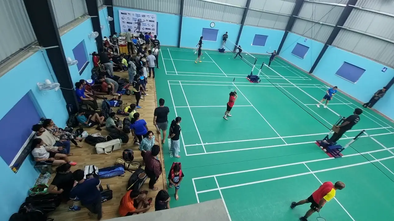 Players on five indoor badminton courts in a steel-framed hall built by Kelysports, Hyderabad